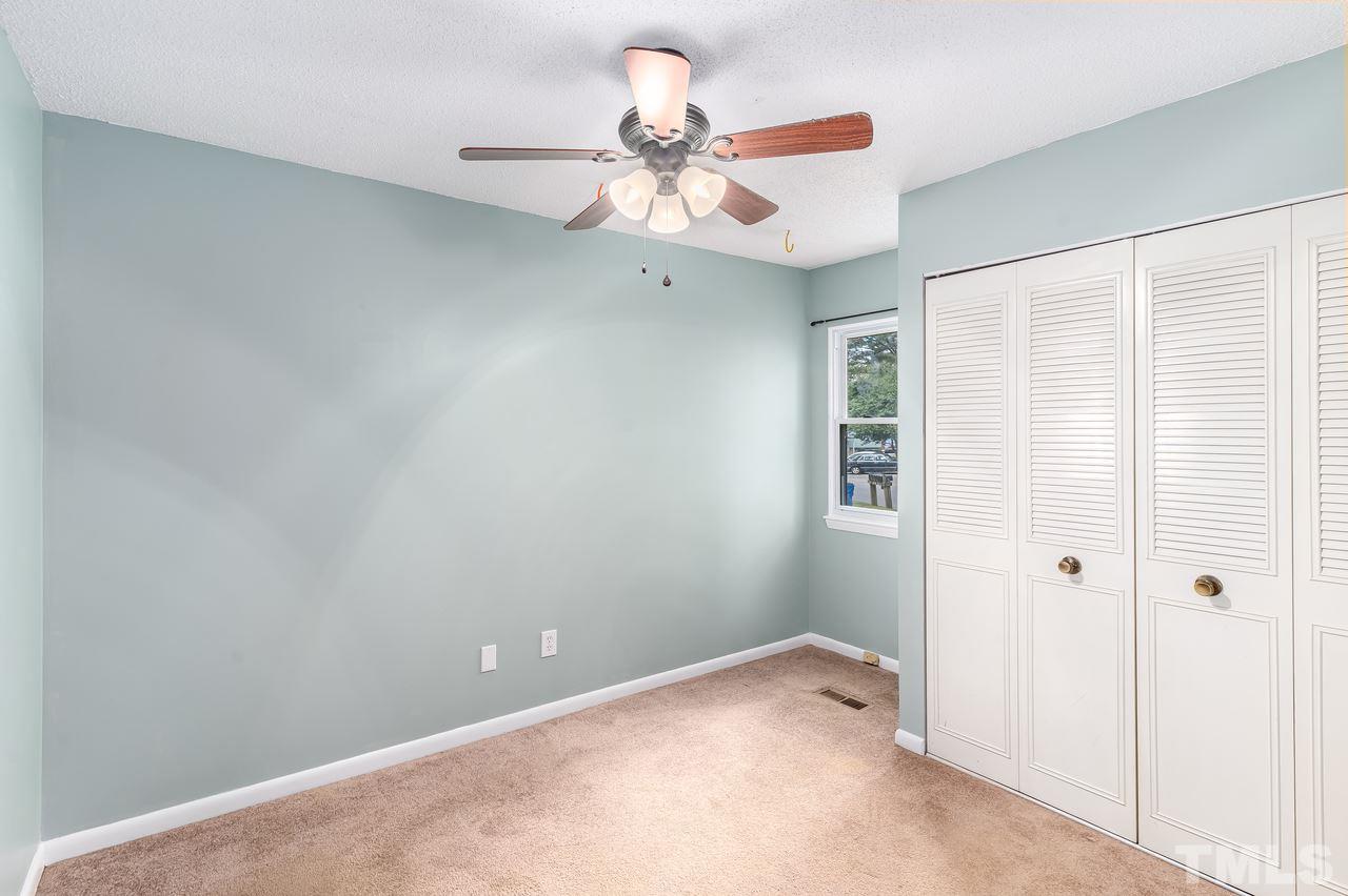 707 Godwin Court Raleigh, NC 27606 - Photo 19 of 26 a view of an empty room and a ceiling fan
