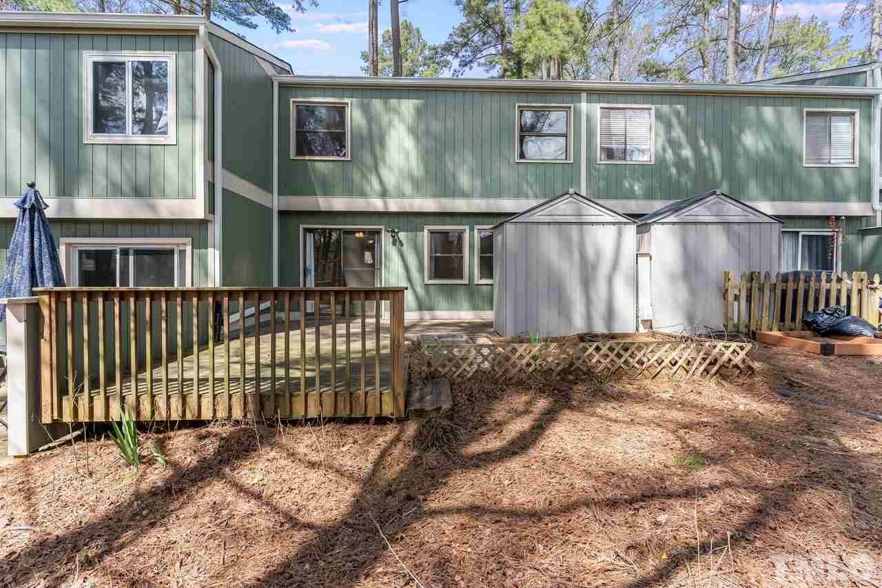 707 Godwin Court Raleigh, NC 27606 - Photo 22 of 26 a view of a house with a small yard and wooden fence