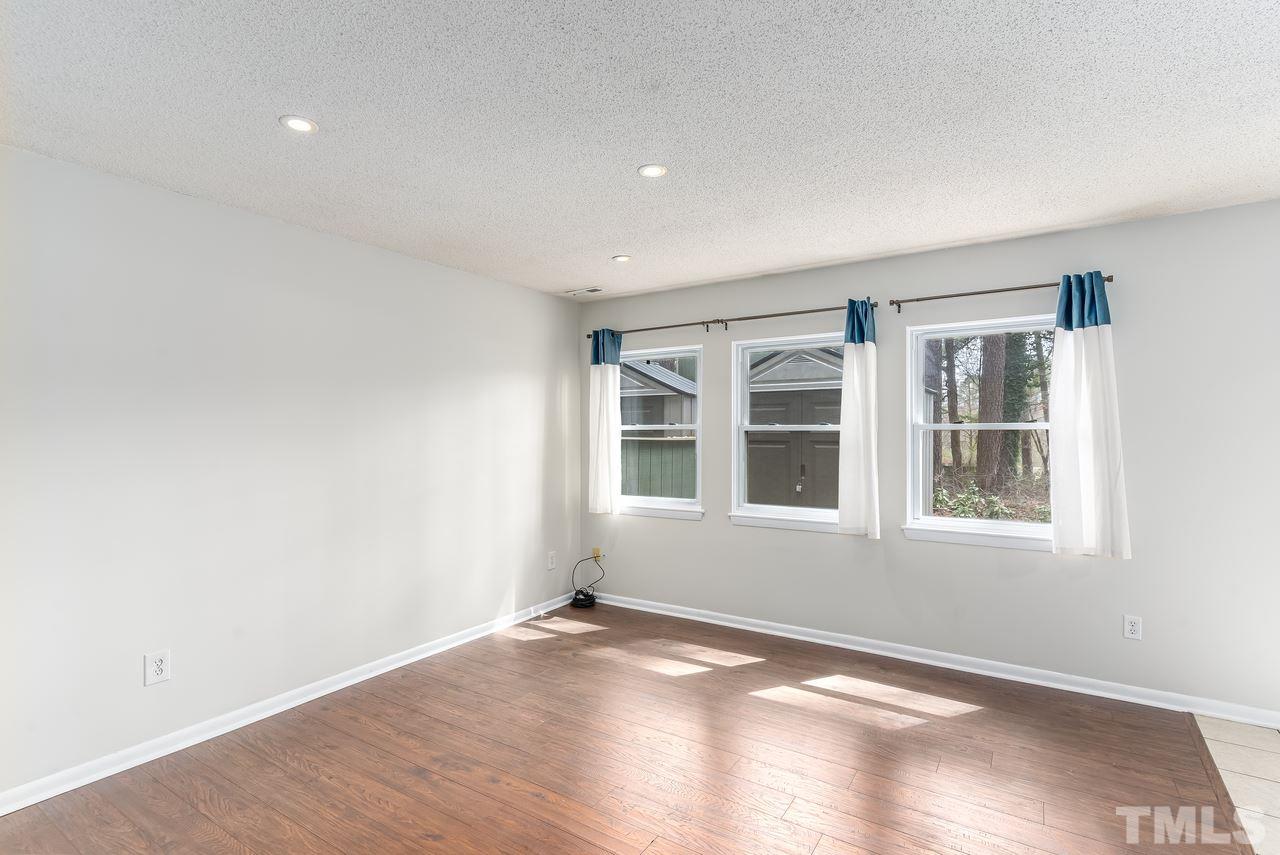 707 Godwin Court Raleigh, NC 27606 - Photo 4 of 26 wooden floor in an empty room with a window