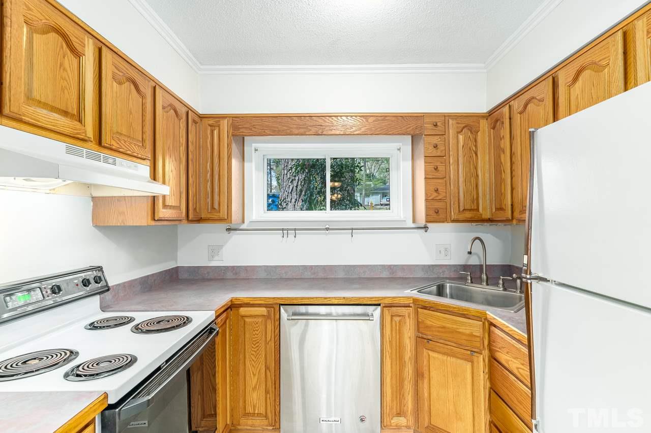 707 Godwin Court Raleigh, NC 27606 - Photo 10 of 26 a kitchen with stainless steel appliances granite countertop a sink and a stove