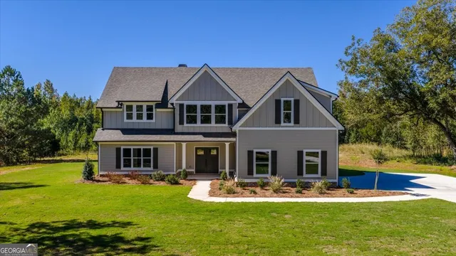 a front view of house with yard and swimming pool