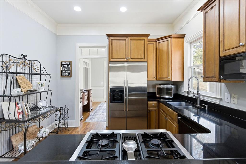 80 Fowler Avenue Roswell, GA 30075 - Photo 23 of 74 a kitchen with granite countertop a stove a sink and a microwave