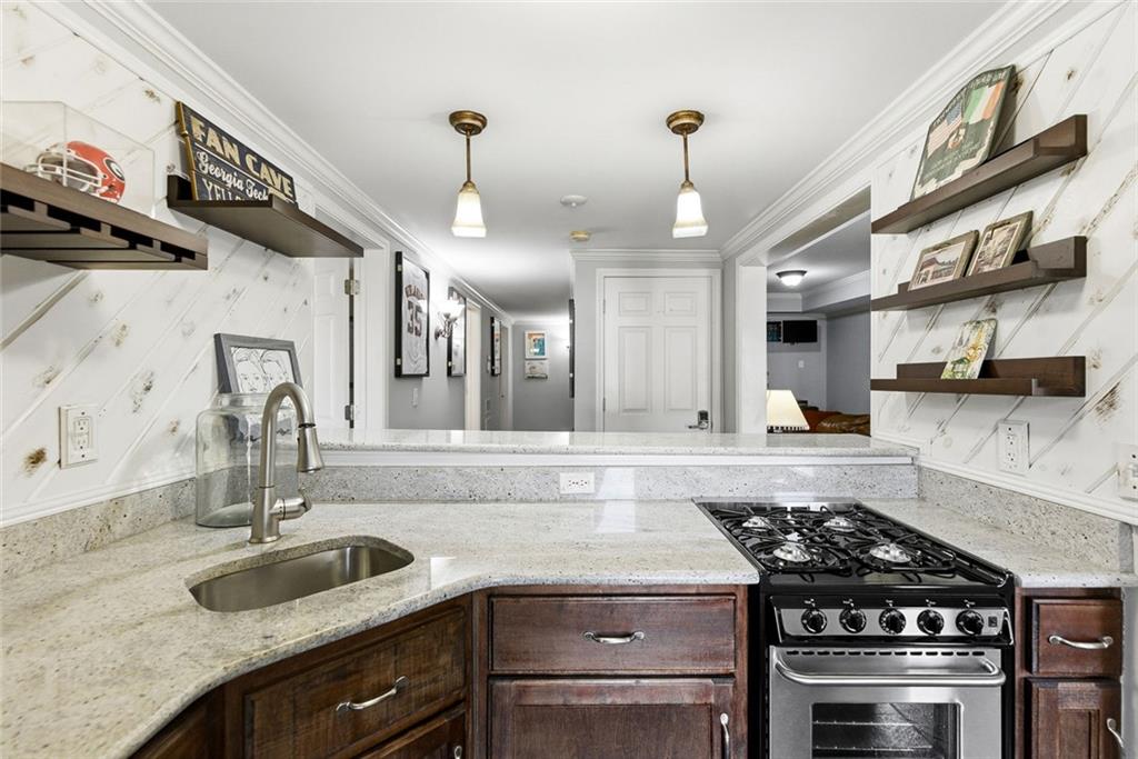 80 Fowler Avenue Roswell, GA 30075 - Photo 53 of 74 a kitchen with stainless steel appliances granite countertop a sink stove and cabinets
