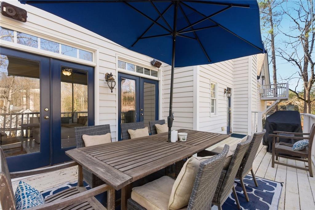 80 Fowler Avenue Roswell, GA 30075 - Photo 54 of 74 a view of a patio with table and chairs under an umbrella