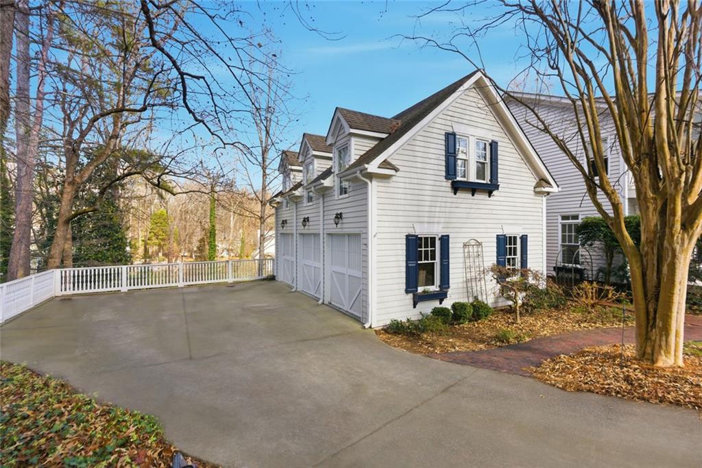 80 Fowler Avenue Roswell, GA 30075 - Photo 62 of 74 a view of a white house next to a road and trees