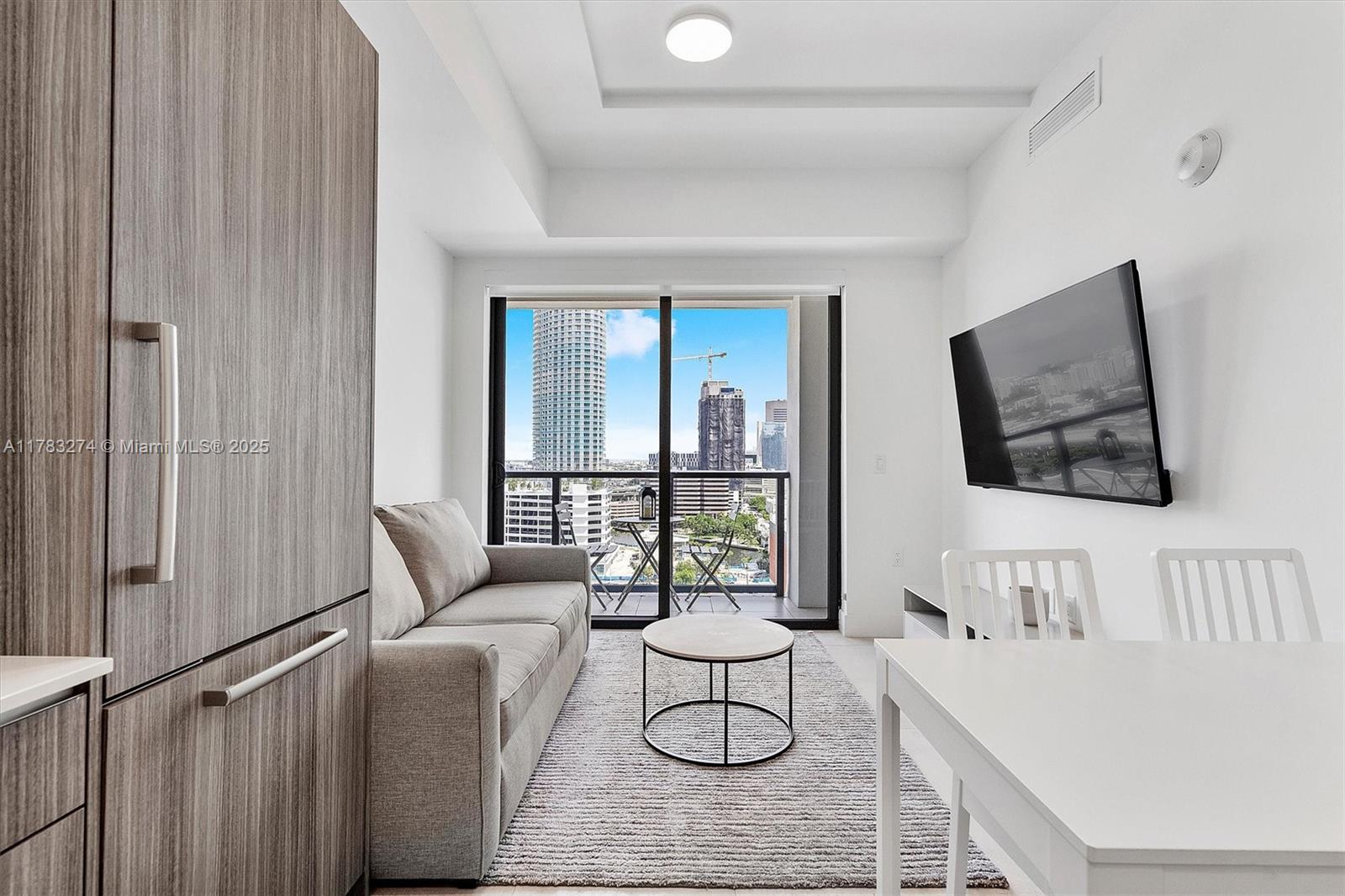 239 Southwest 9th Street, Unit 1704 Miami, FL 33130 - Photo 5 of 36 a living room with furniture and a table
