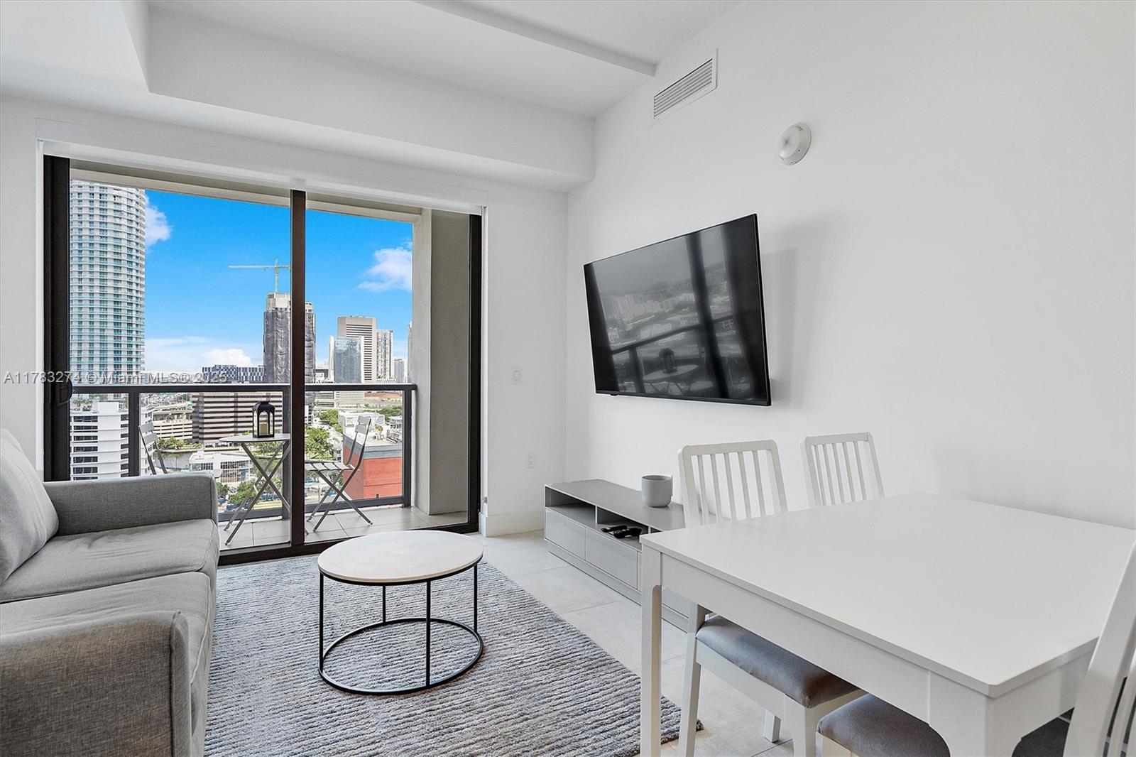 239 Southwest 9th Street, Unit 1704 Miami, FL 33130 - Photo 6 of 36 a living room with furniture and a large window