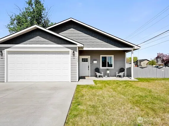 a view of a house with backyard and porch
