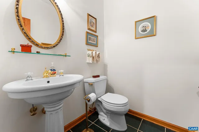 a kitchen that has a sink a stove and chairs