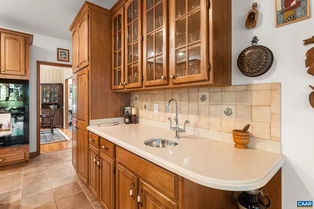 a bathroom with a tub a sink and a large window