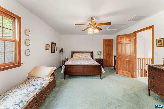 a view of empty room with stairs and mirrors
