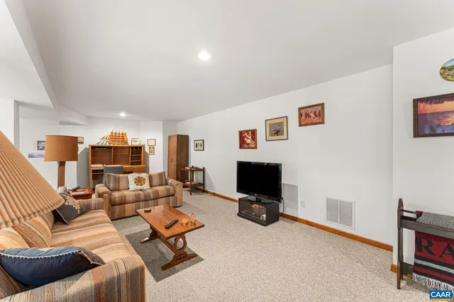 a kitchen with granite countertop wooden cabinets a sink a stove and a window