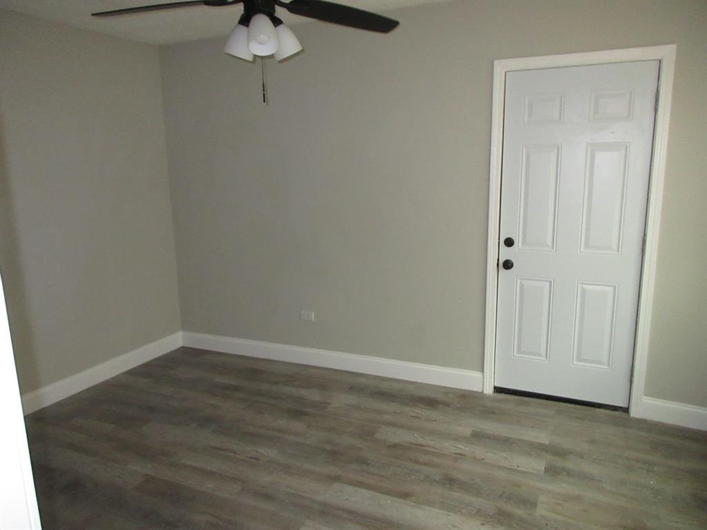 328 South Talton Street Minden, LA 71055 - Photo 11 of 21 a view of a room with wooden floor and brick walls