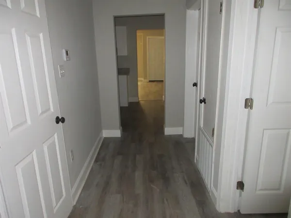 a view of a hallway with wooden floor