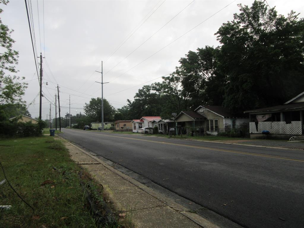 328 South Talton Street Minden, LA 71055 - Photo 20 of 21 a city view with large trees and cars parked on the side of road