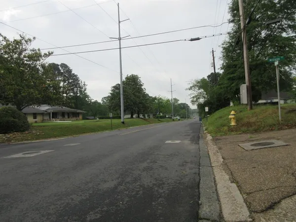 a view of a road with a big yard