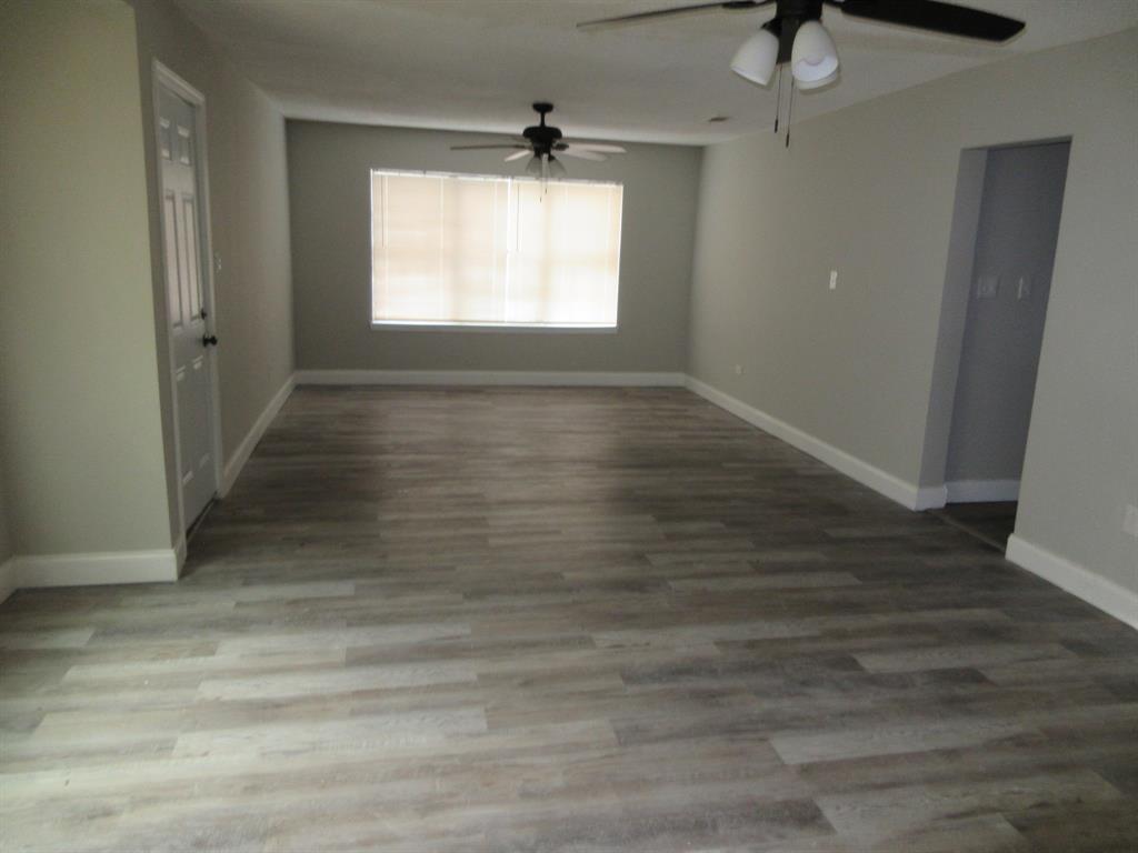 328 South Talton Street Minden, LA 71055 - Photo 3 of 21 an empty room with wooden floor and windows