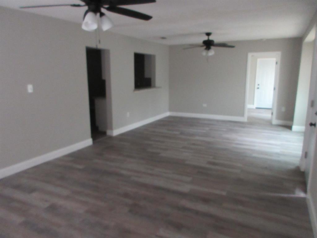 328 South Talton Street Minden, LA 71055 - Photo 4 of 21 a view of an empty room with a ceiling fan