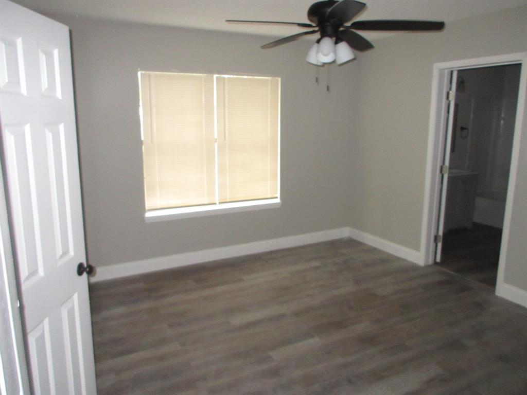 328 South Talton Street Minden, LA 71055 - Photo 10 of 21 an empty room with wooden floor fan and windows