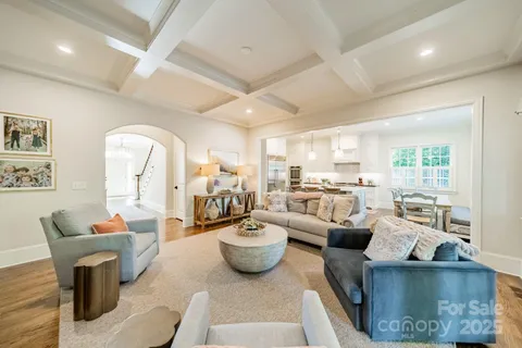 a living room with furniture a fireplace and a large window