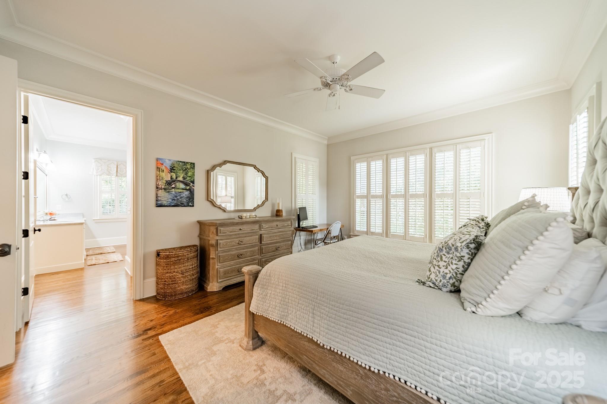 4141 Tyng Way Charlotte, NC 28211 - Photo 18 of 48 a bedroom with a bed a mirror on dresser and a chandelier