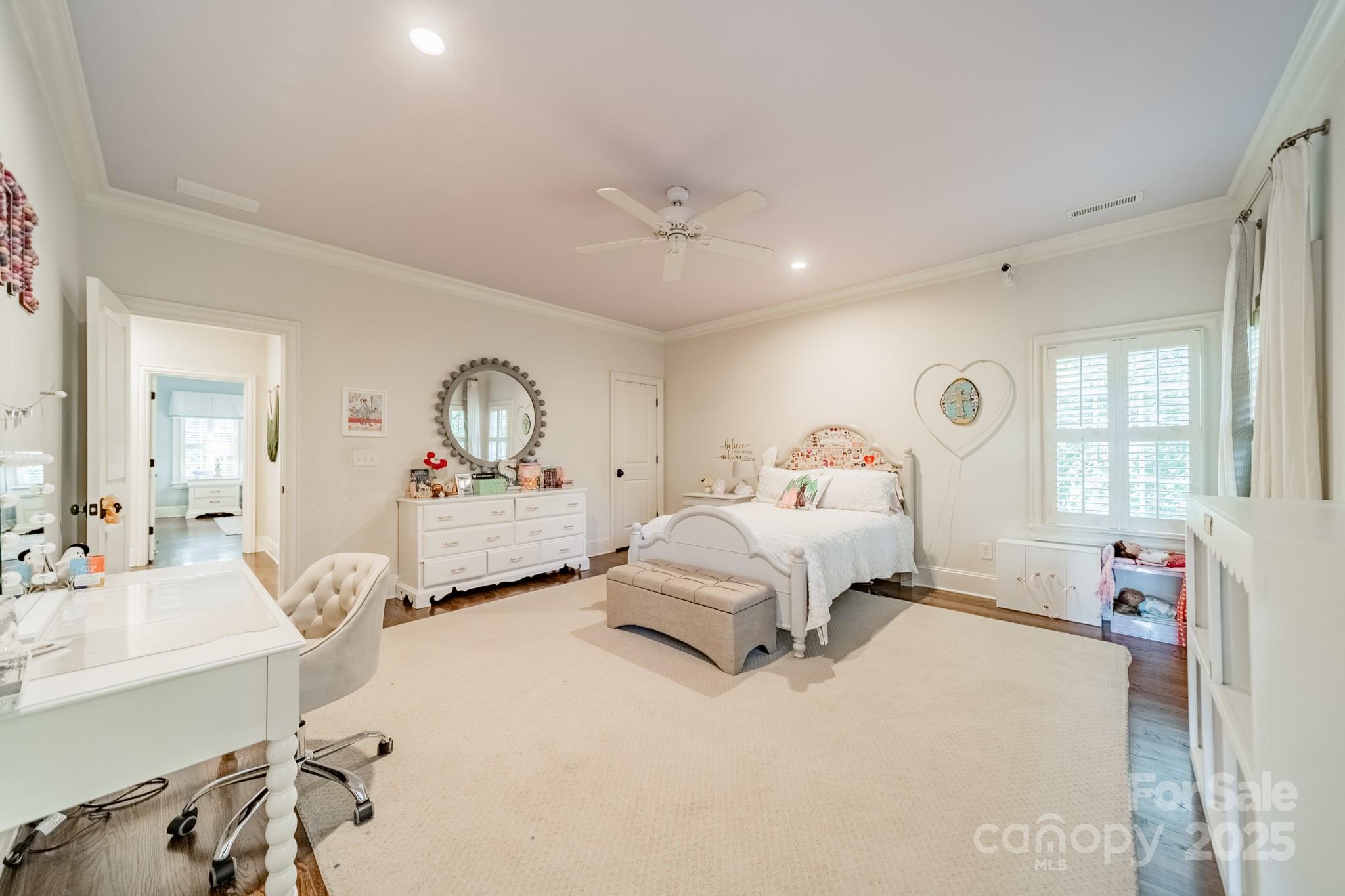 4141 Tyng Way Charlotte, NC 28211 - Photo 27 of 48 a bedroom with a bed and a chandelier