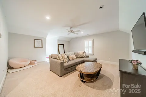 a living room with furniture a rug and white walls