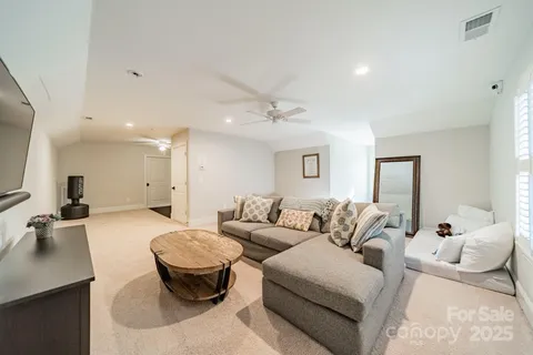 a living room with furniture and a large mirror