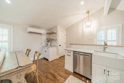 a spacious bathroom with a double vanity sink a mirror and a bathtub