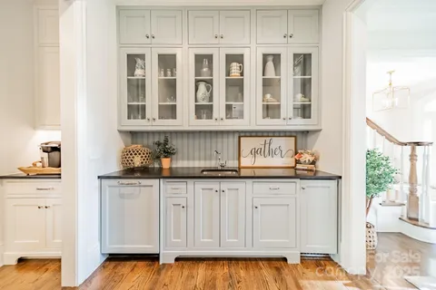 a kitchen with granite countertop a sink and cabinets