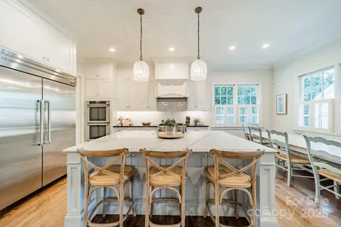 a large kitchen with a table and chairs