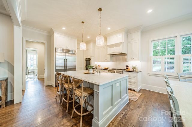 a large kitchen with kitchen island a large island in it