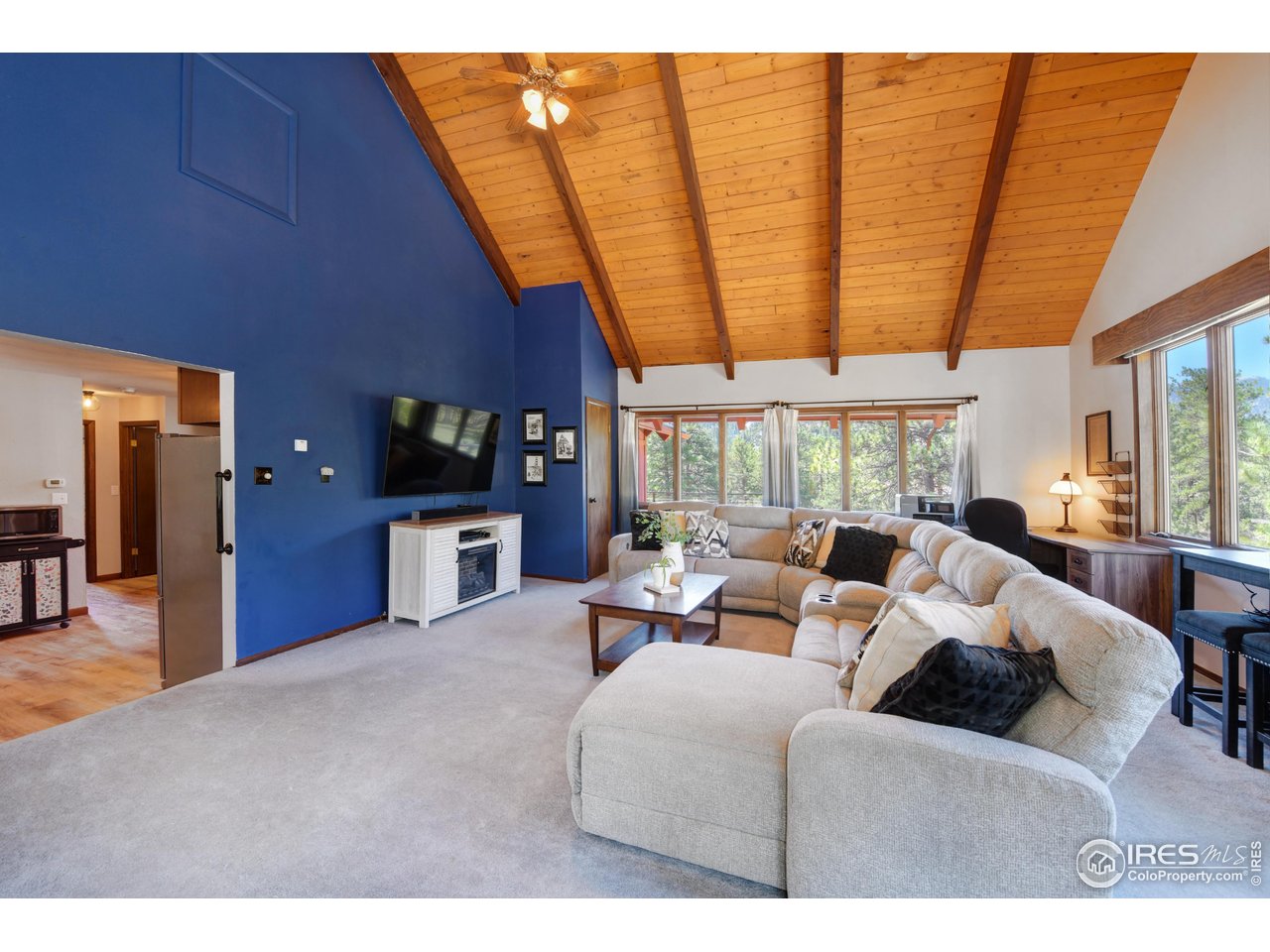 40 Hopi Court Lyons, CO 80540 - Photo 14 of 40 a living room with furniture a large window and chandelier