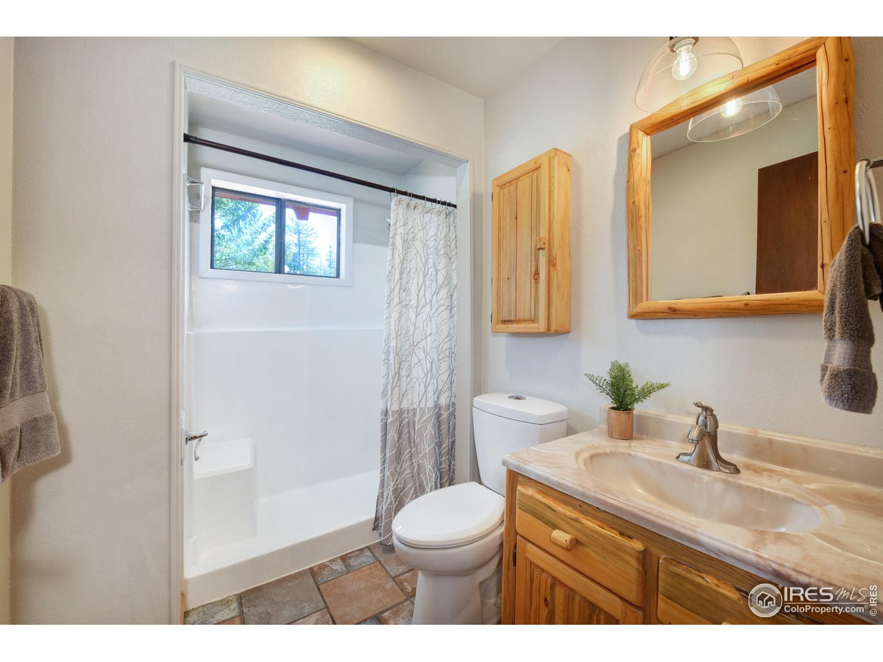 40 Hopi Court Lyons, CO 80540 - Photo 17 of 40 a bathroom with a granite countertop toilet sink and mirror