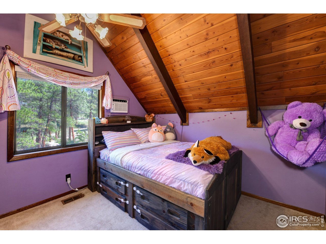 40 Hopi Court Lyons, CO 80540 - Photo 20 of 40 a bedroom with a bed and wooden floor
