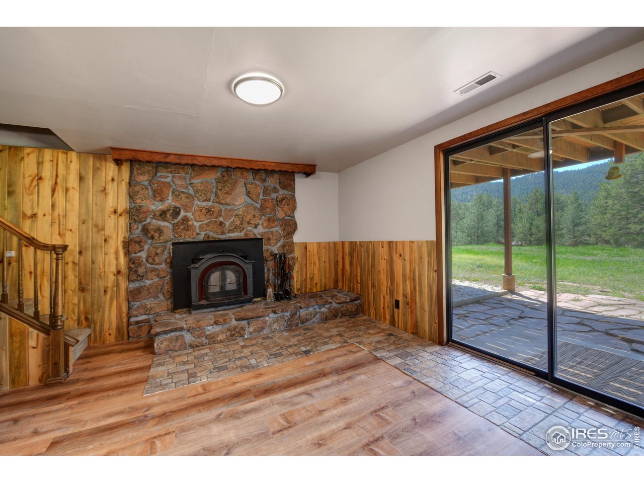 40 Hopi Court Lyons, CO 80540 - Photo 29 of 40 a view of empty room with wooden floor and fireplace