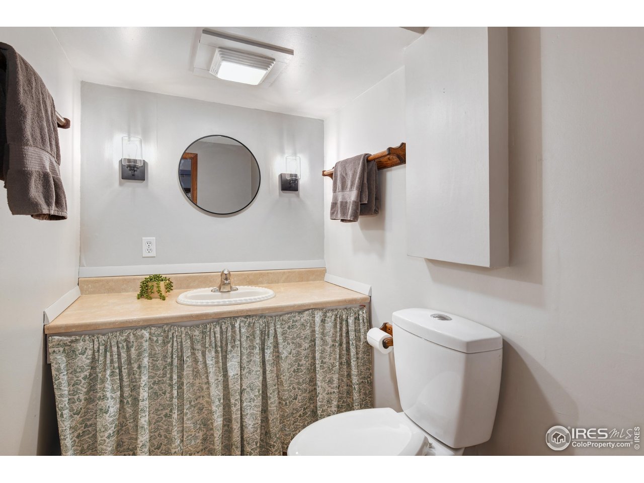 40 Hopi Court Lyons, CO 80540 - Photo 31 of 40 a bathroom with a sink a toilet and mirror