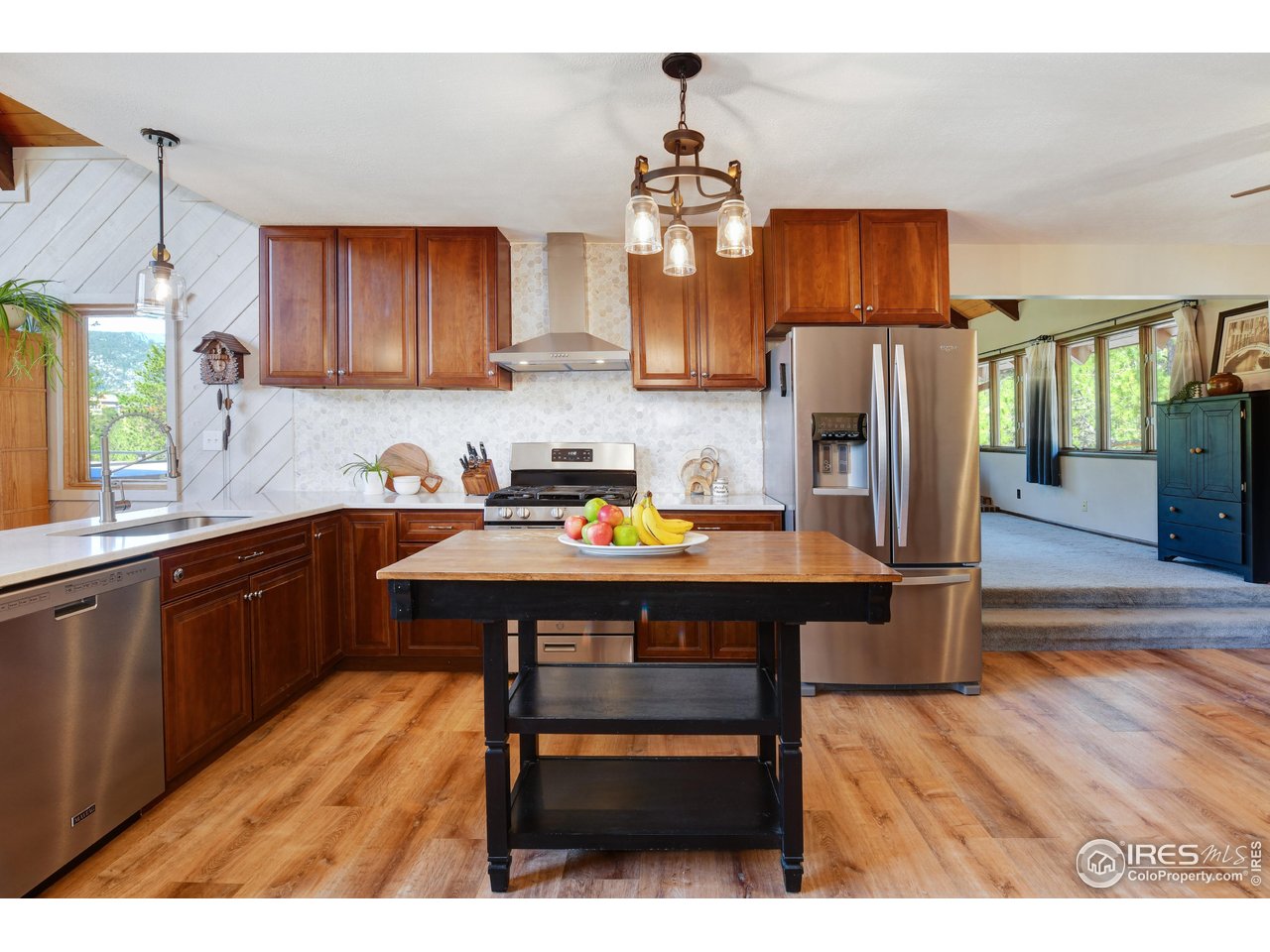 40 Hopi Court Lyons, CO 80540 - Photo 5 of 40 a kitchen with stainless steel appliances wooden floors wooden table and chairs
