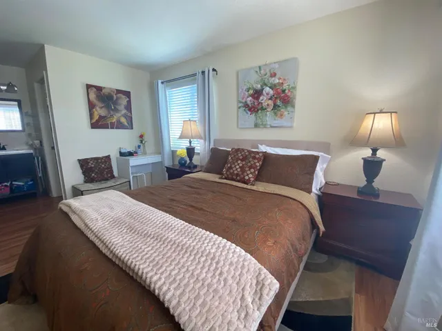 a view of a room with wooden floor and a window