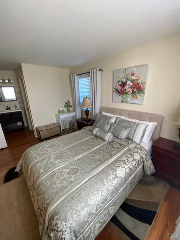 a view of a balcony with chairs and a potted plant