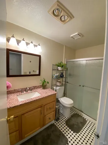 a kitchen with granite countertop wooden cabinets a sink and a stove