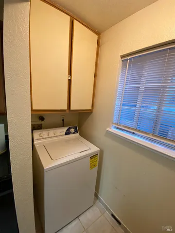 a bathroom with a granite countertop sink and a toilet