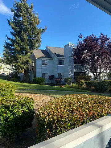 a view of a house with a yard and garden