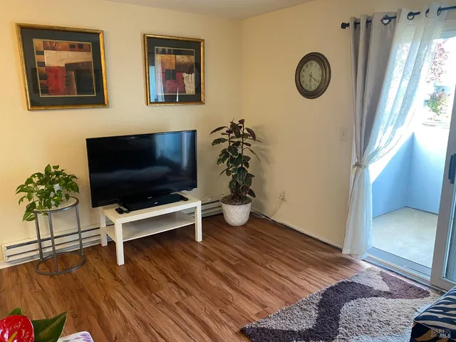 a view of a dining room with furniture and a window
