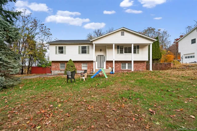 a front view of a house with a yard and porch
