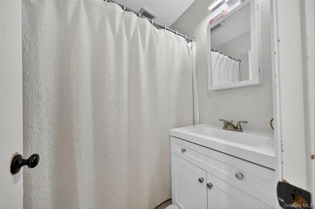 a bathroom with a sink a vanity and a mirror