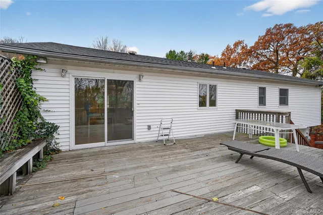 a view of a chair and table in backyard of the house
