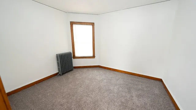 a view of an empty room and a window