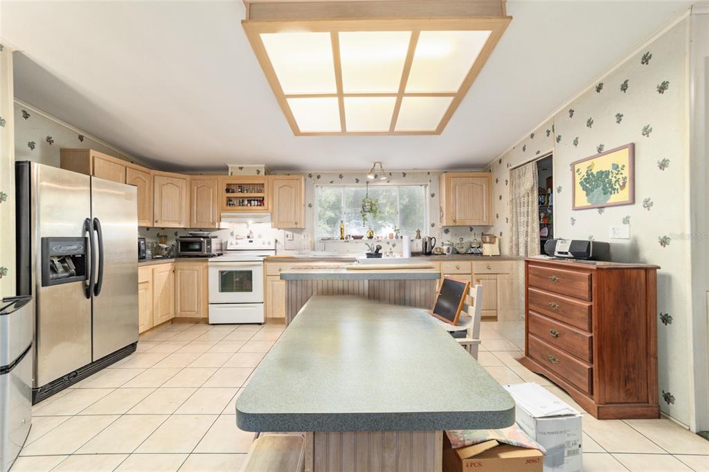10630 Northwest 10th Street Road Ocala, FL 34482 - Photo 11 of 29 a kitchen with a refrigerator sink and cabinets