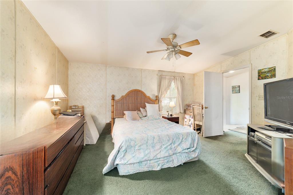 10630 Northwest 10th Street Road Ocala, FL 34482 - Photo 15 of 29 a bedroom with a bed and a flat screen tv